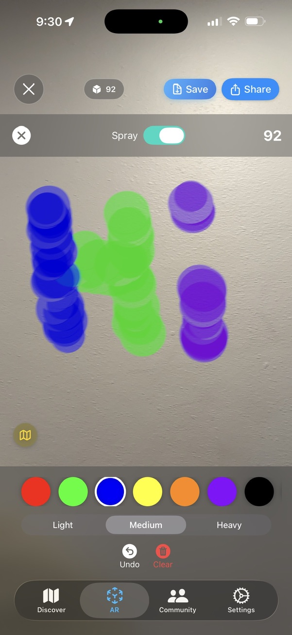 Screenshot of AR graffiti spelling Hi spray-painted on a real wall, with a color palette and spray controls